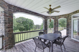 17 Cricket Hill Road Hawley, PA 18428 - Photo 19 of 93 a view of a patio with a table chairs and a floor to ceiling window