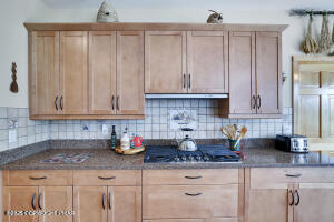 17 Cricket Hill Road Hawley, PA 18428 - Photo 23 of 93 a kitchen with stainless steel appliances granite countertop a sink a refrigerator and cabinets