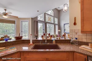 a spacious bedroom with a balcony a bed and a chandelier