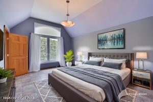 17 Cricket Hill Road Hawley, PA 18428 - Photo 47 of 93 a spacious bedroom with a balcony a bed and a chandelier