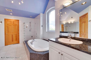 17 Cricket Hill Road Hawley, PA 18428 - Photo 50 of 93 a bathroom with a granite countertop sink and a mirror
