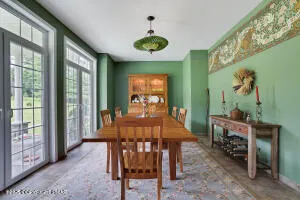 a living room with furniture a fireplace and a large window