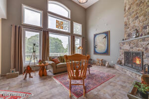 17 Cricket Hill Road Hawley, PA 18428 - Photo 10 of 93 a living room with furniture a fireplace and a large window