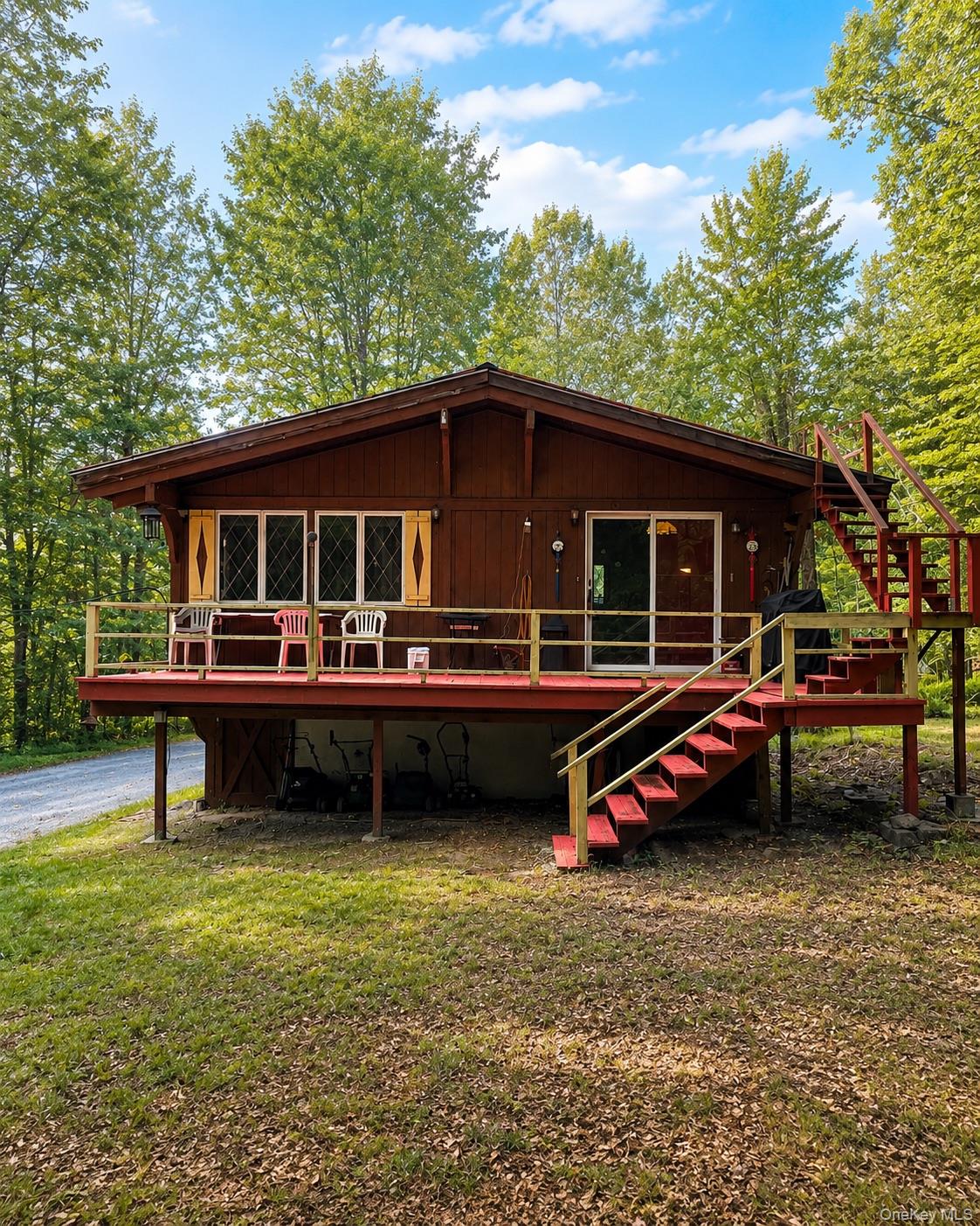 177 Davos Road Woodridge, NY 12789 - Photo 1 of 19 a front view of a house with a garden and deck