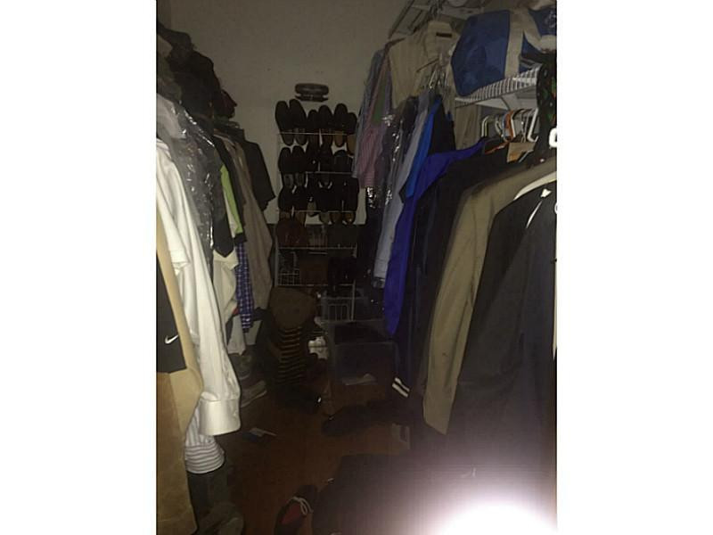 21080 Woodspring Avenue Boca Raton, FL 33428 - Photo 11 of 20 a view of walk in closet with clothes and shoes