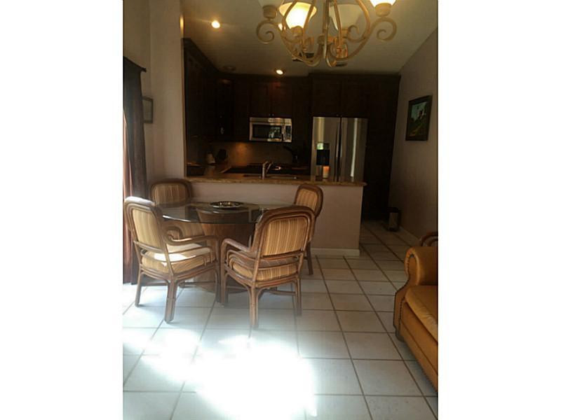 21080 Woodspring Avenue Boca Raton, FL 33428 - Photo 12 of 20 a dining room with furniture and a chandelier