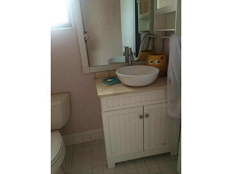 21080 Woodspring Avenue Boca Raton, FL 33428 - Photo 14 of 20 a bathroom with a sink and a mirror