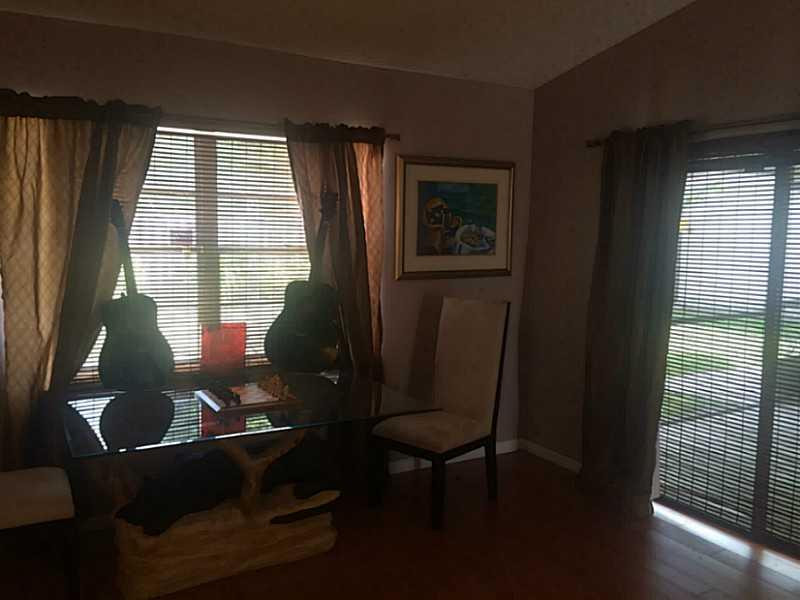 21080 Woodspring Avenue Boca Raton, FL 33428 - Photo 16 of 20 a living room with furniture and a window