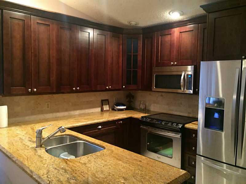 21080 Woodspring Avenue Boca Raton, FL 33428 - Photo 3 of 20 a kitchen with a sink stove and microwave