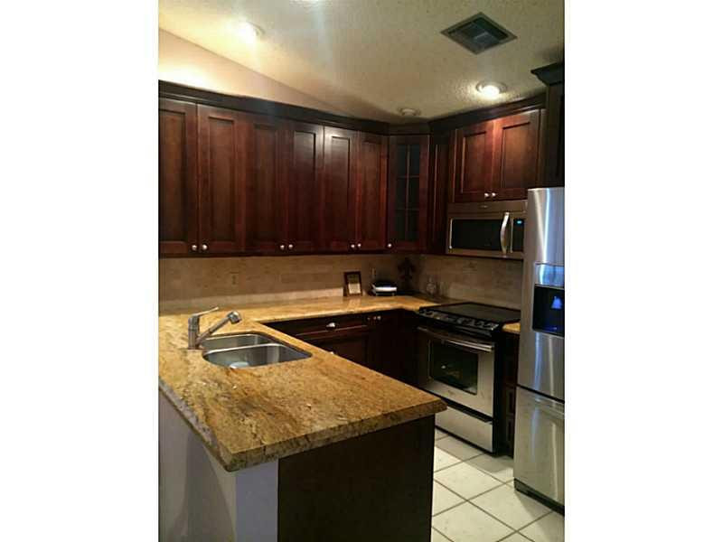 21080 Woodspring Avenue Boca Raton, FL 33428 - Photo 4 of 20 a kitchen with a sink and cabinets