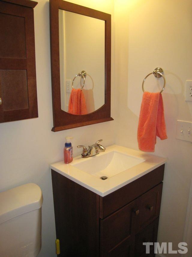 3712 Allen Street West Raleigh, NC 27603 - Photo 11 of 23 a bathroom with a sink mirror vanity and toilet