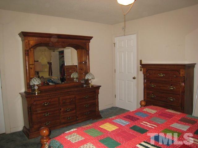 3712 Allen Street West Raleigh, NC 27603 - Photo 15 of 23 a bedroom with a bed and a dresser