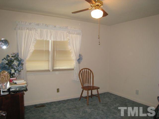 3712 Allen Street West Raleigh, NC 27603 - Photo 17 of 23 a view of a room with a chandelier and wooden floor