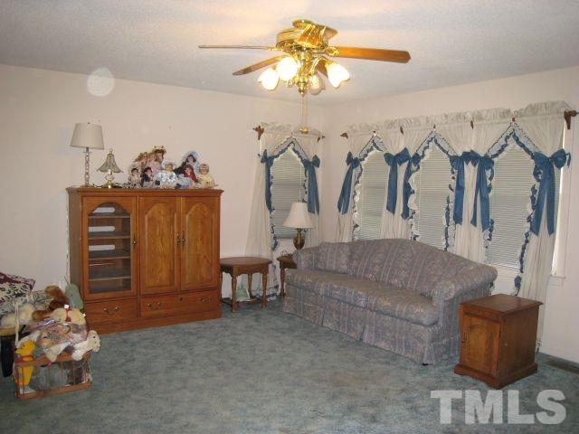 3712 Allen Street West Raleigh, NC 27603 - Photo 3 of 23 a living room with furniture and a chandelier