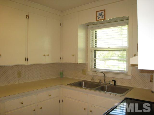 3712 Allen Street West Raleigh, NC 27603 - Photo 7 of 23 a bathroom with a sink and a window