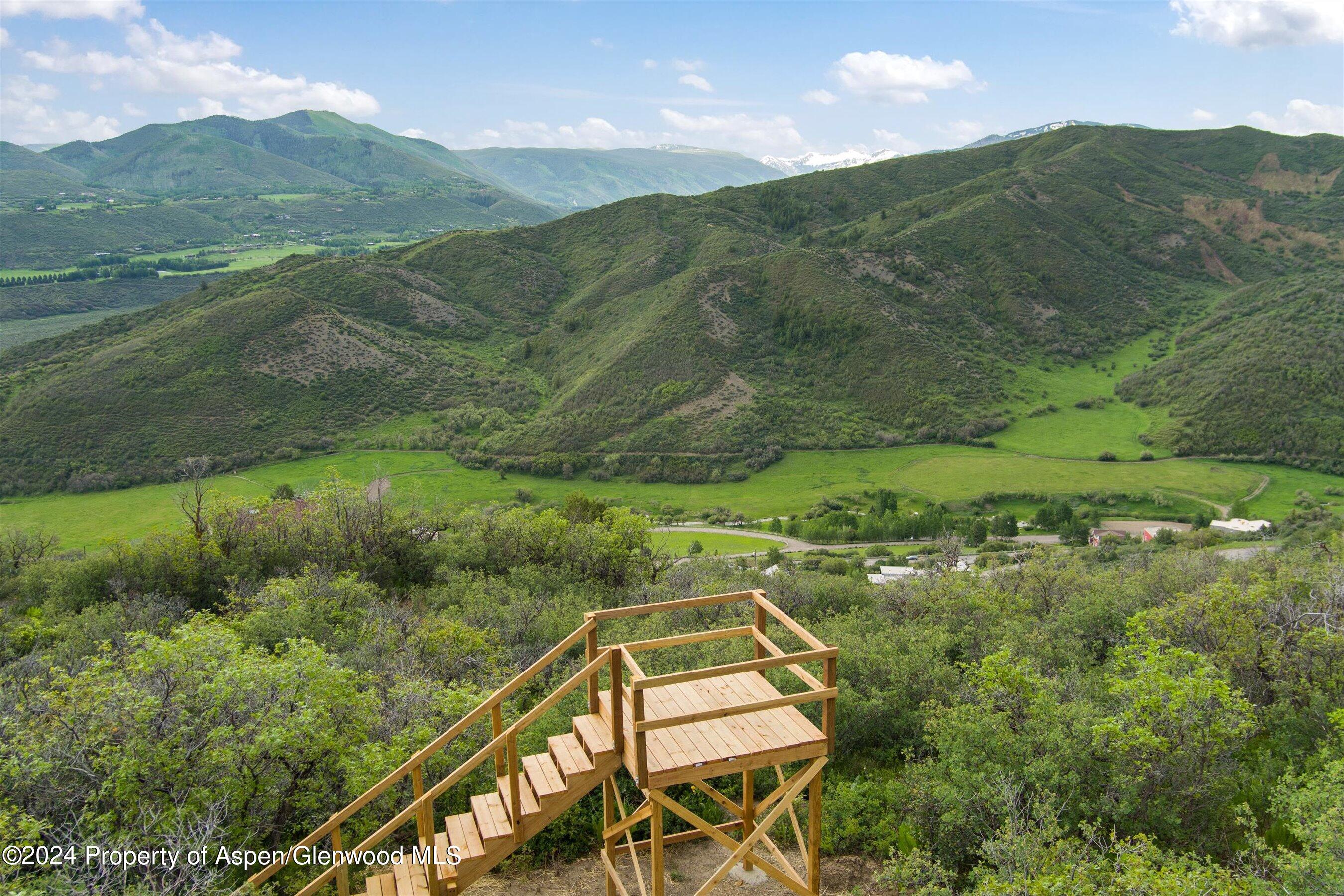 148 Tabula Rasa Lane Aspen, CO 81611 - Photo 11 of 15 a view of a lush green hillside and houses