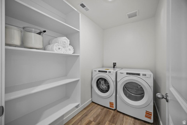 2216 Wolverine Way Washington, UT 84780 - Photo 19 of 29 Dedicated laundry space featuring wood-finish flooring, white walls, and built-in shelving