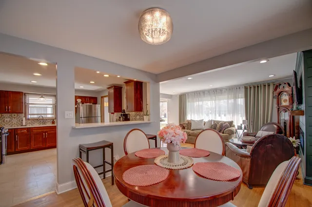 a dinning room filled chandelier and furniture