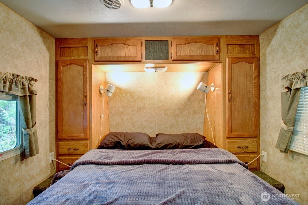 38 Gold Nuget Road Deming, WA 98244 - Photo 16 of 36 a bedroom with a bed and a large mirror next to a window
