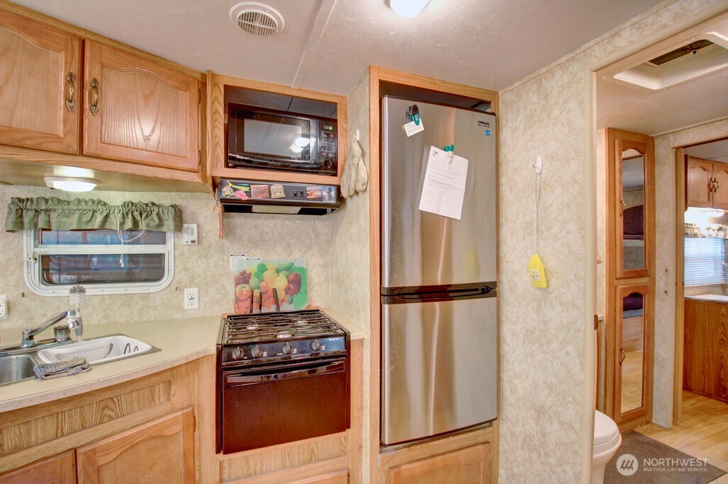 38 Gold Nuget Road Deming, WA 98244 - Photo 9 of 36 a kitchen with a refrigerator and a sink