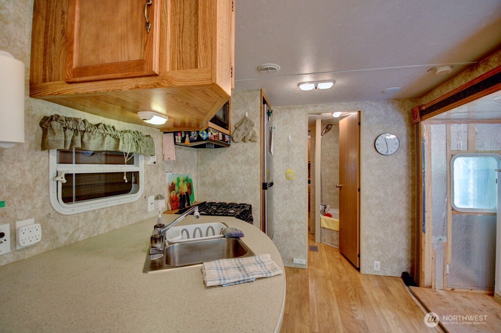 38 Gold Nuget Road Deming, WA 98244 - Photo 10 of 36 a kitchen with stainless steel appliances a stove a refrigerator a sink and cabinets