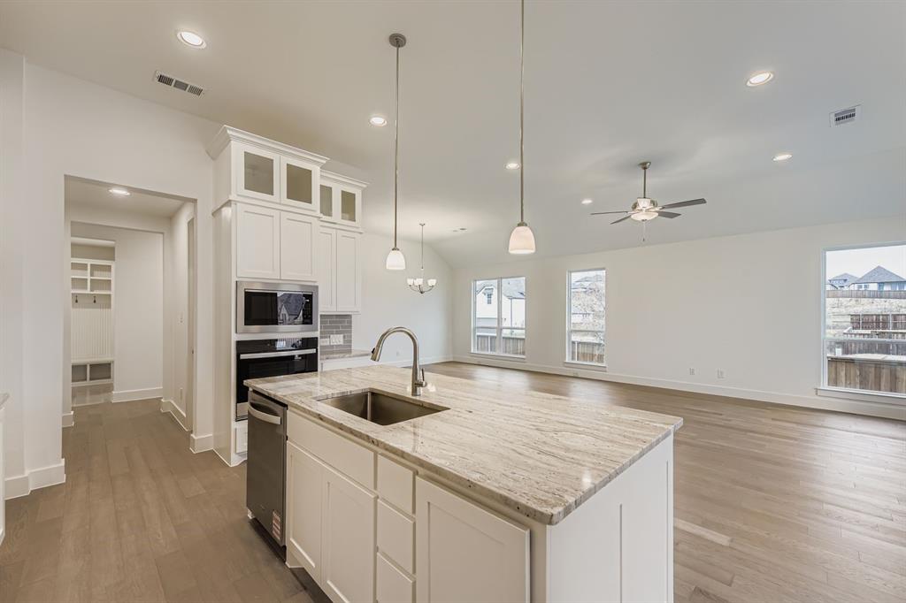 154 Longhorn Bend Rhome, TX 76078 - Photo 13 of 25 a kitchen with kitchen island a sink stove and refrigerator