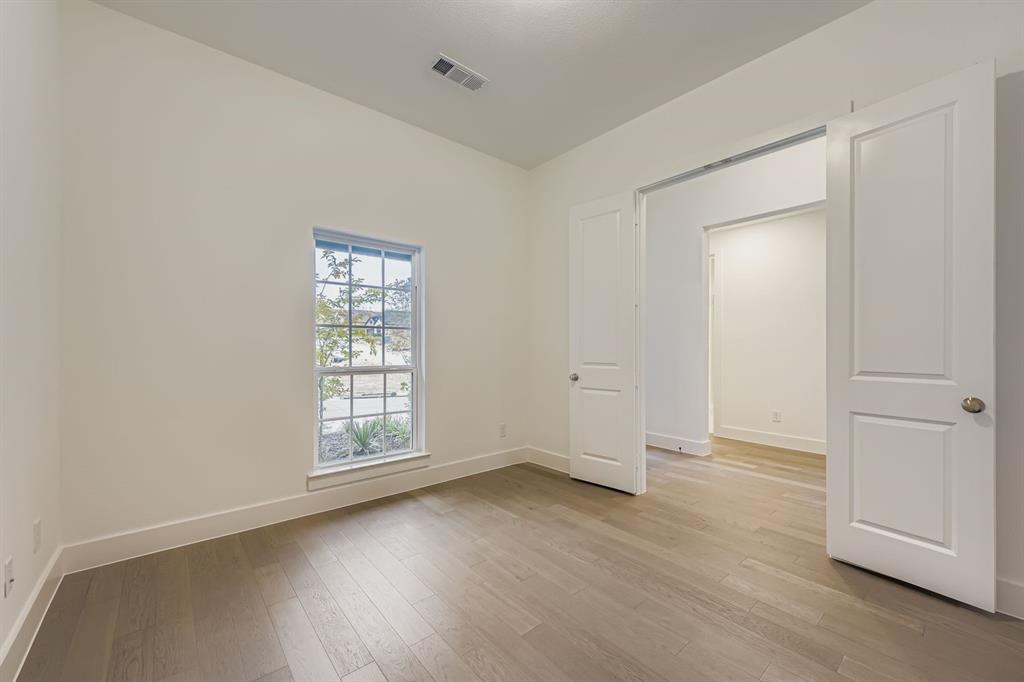 154 Longhorn Bend Rhome, TX 76078 - Photo 15 of 25 an empty room with wooden floor and window