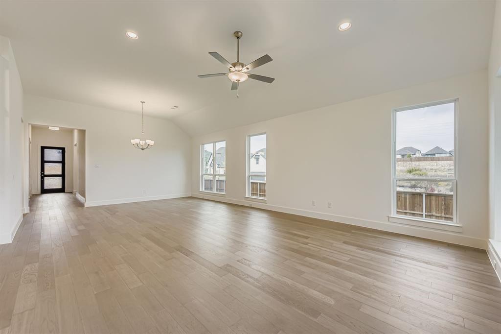 154 Longhorn Bend Rhome, TX 76078 - Photo 4 of 25 a view of an empty room with a window and wooden floor
