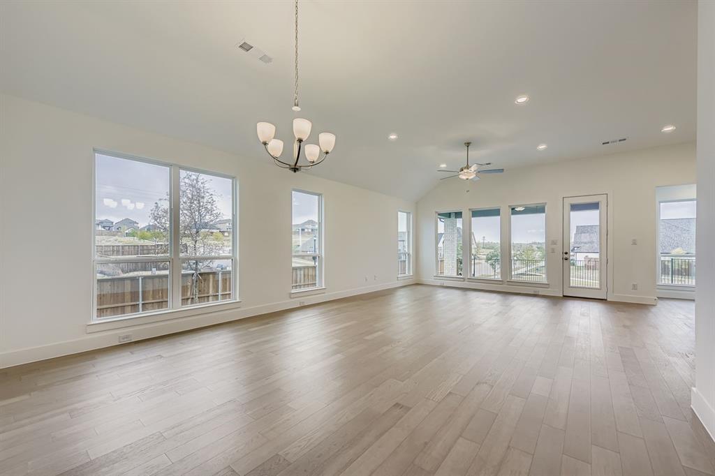 154 Longhorn Bend Rhome, TX 76078 - Photo 8 of 25 a view of an empty room with wooden floor and a window