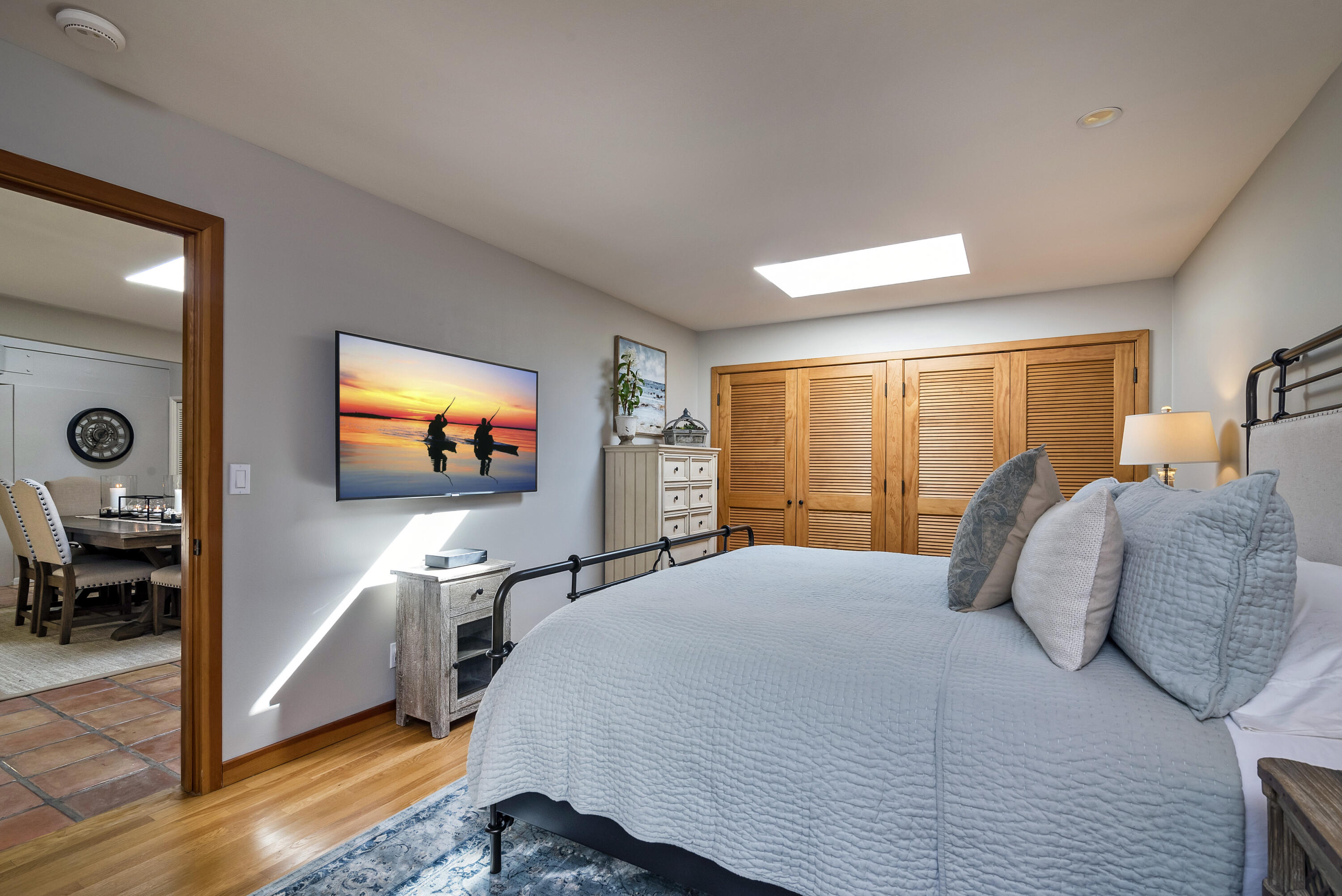 548 San Ysidro Road, Unit 1 Santa Barbara, CA 93108 - Photo 8 of 20 a bedroom with a bed and a flat screen tv