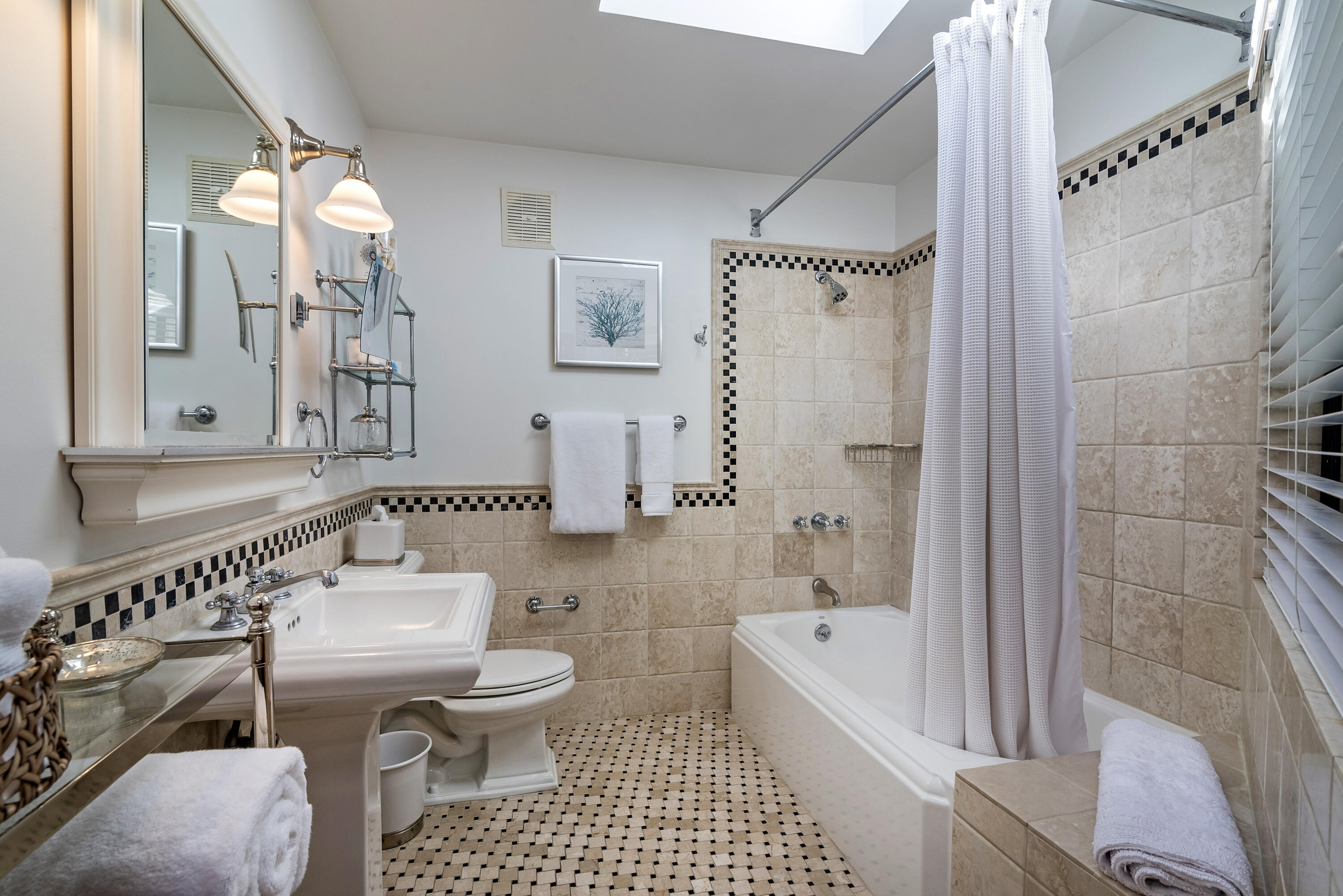548 San Ysidro Road, Unit 1 Santa Barbara, CA 93108 - Photo 10 of 20 a bathroom with a toilet a sink and a bathtub
