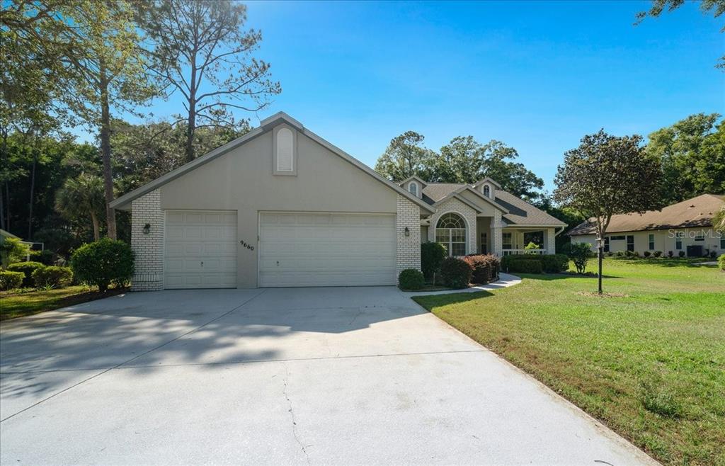 9660 Southwest 196th Avenue Road Dunnellon, FL 34432 - Photo 12 of 67 a front view of a house with a yard and garage