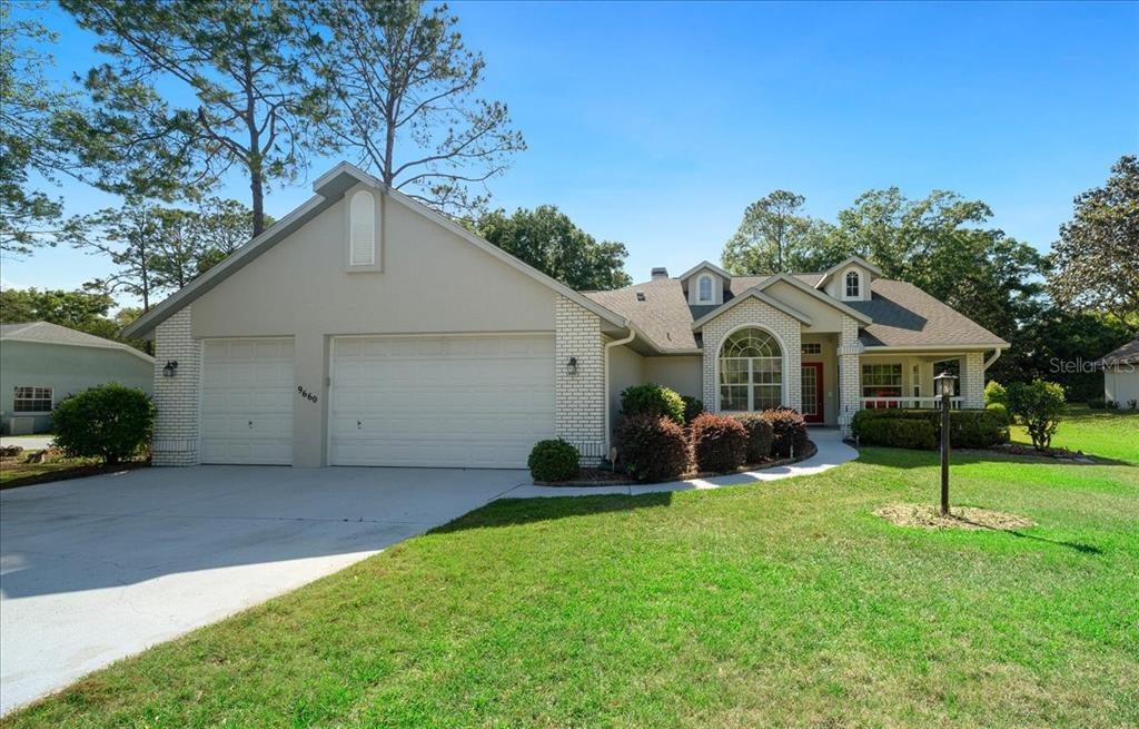 9660 Southwest 196th Avenue Road Dunnellon, FL 34432 - Photo 15 of 67 a view of a white house with a yard and a large tree