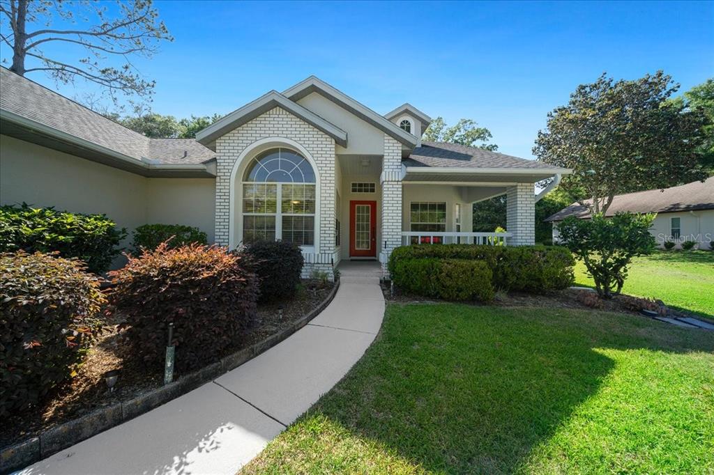9660 Southwest 196th Avenue Road Dunnellon, FL 34432 - Photo 16 of 67 a front view of a house with a garden