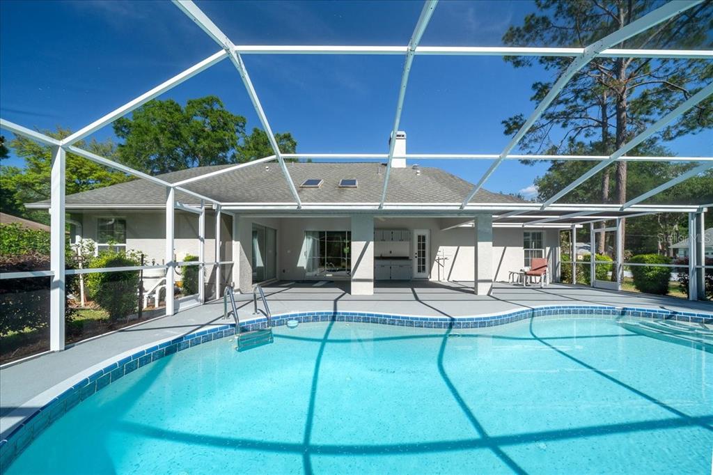 9660 Southwest 196th Avenue Road Dunnellon, FL 34432 - Photo 26 of 67 a view of a patio with table and chairs a barbeque with wooden fence