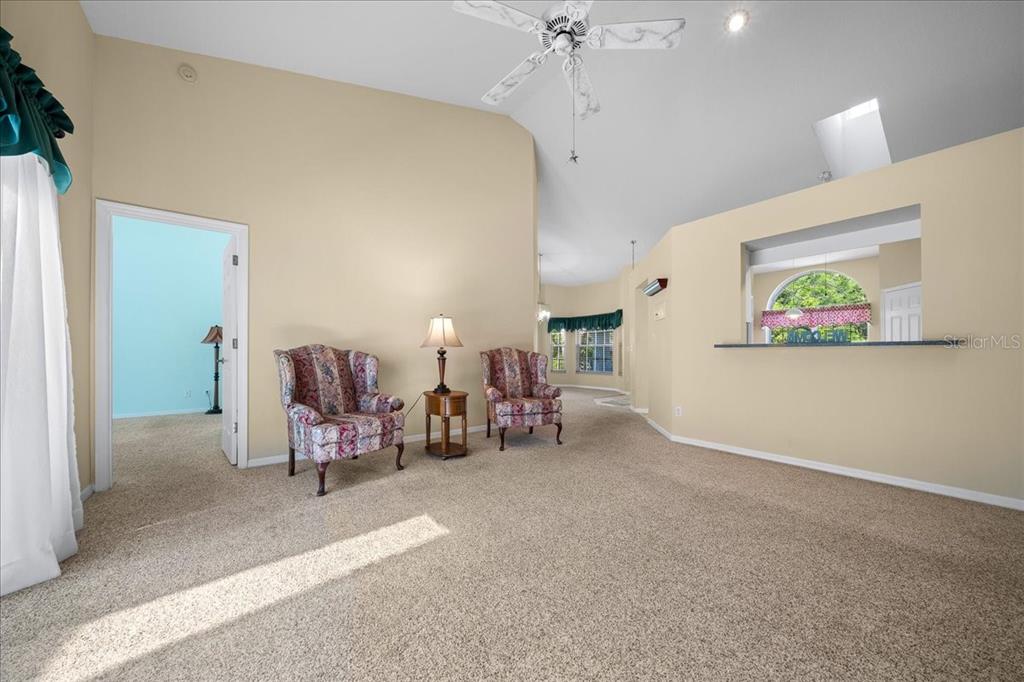 9660 Southwest 196th Avenue Road Dunnellon, FL 34432 - Photo 36 of 67 a living room with furniture and a chandelier