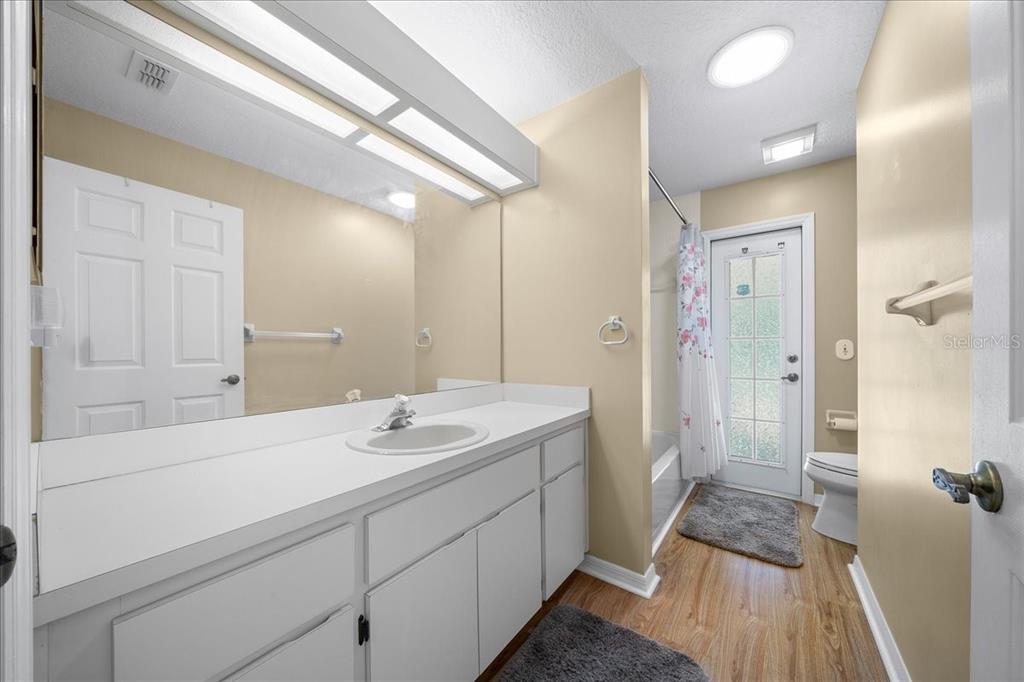 9660 Southwest 196th Avenue Road Dunnellon, FL 34432 - Photo 40 of 67 a spacious bathroom with a sink a mirror a vanity and shower