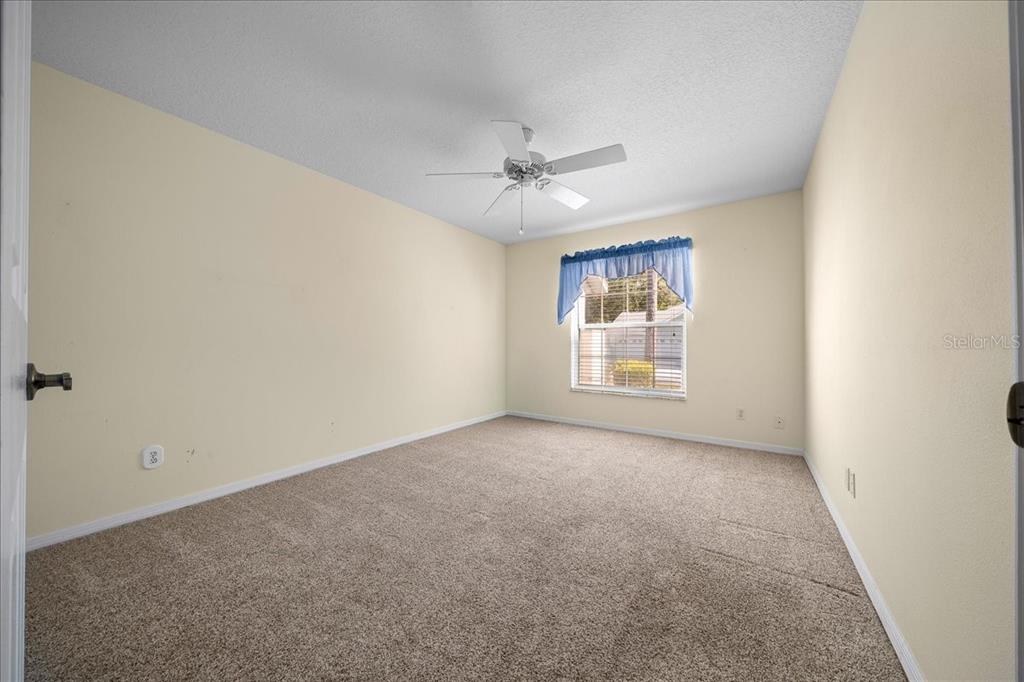 9660 Southwest 196th Avenue Road Dunnellon, FL 34432 - Photo 42 of 67 an empty room with windows and ceiling fan