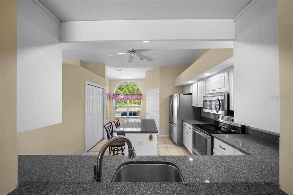 9660 Southwest 196th Avenue Road Dunnellon, FL 34432 - Photo 48 of 67 a kitchen with stainless steel appliances granite countertop a sink a stove and a refrigerator