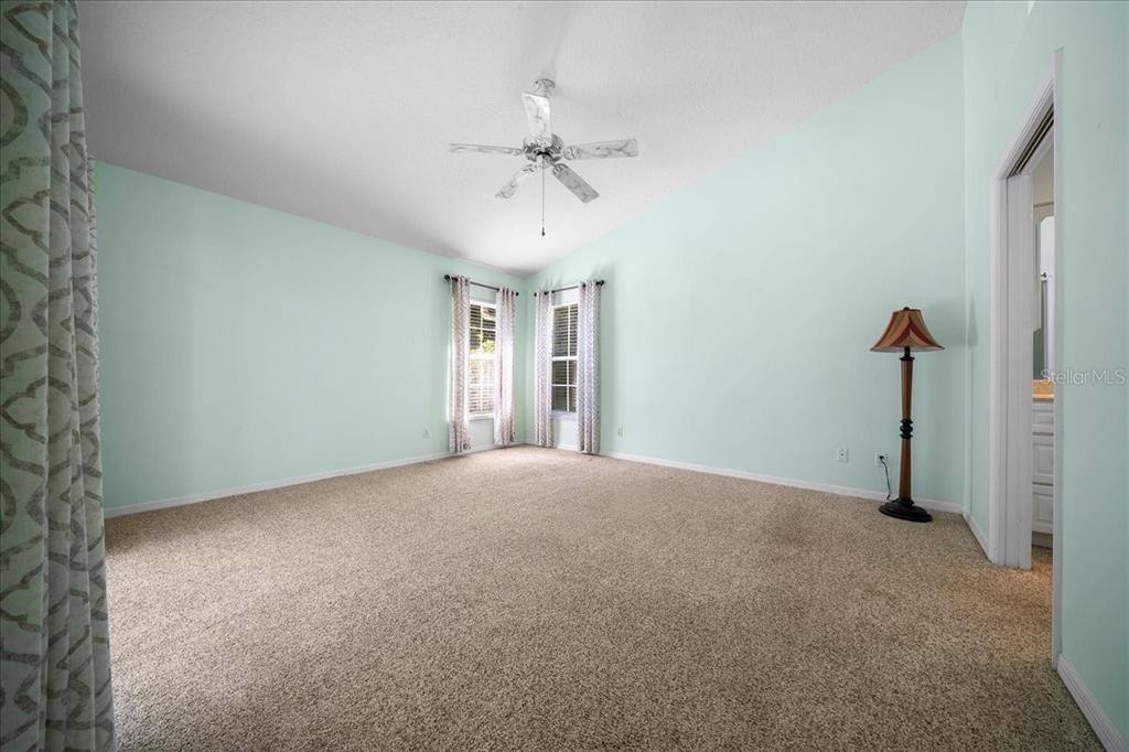 9660 Southwest 196th Avenue Road Dunnellon, FL 34432 - Photo 50 of 67 a view of a room with a ceiling fan and carpet