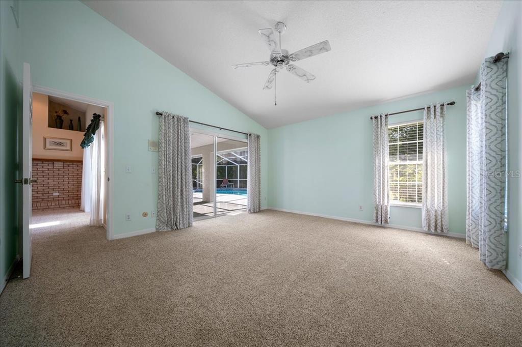 9660 Southwest 196th Avenue Road Dunnellon, FL 34432 - Photo 52 of 67 a view of a big room with windows and chandelier fan