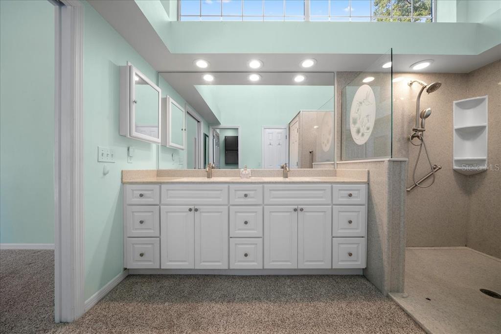 9660 Southwest 196th Avenue Road Dunnellon, FL 34432 - Photo 55 of 67 a spacious bathroom with a granite countertop sink mirror and shower