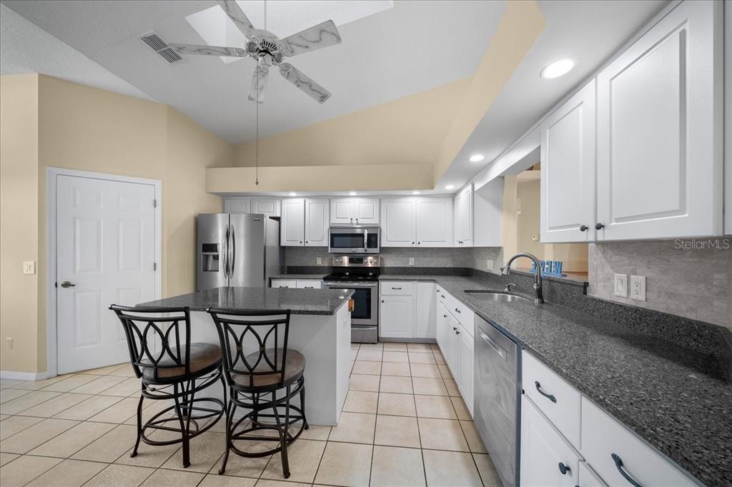 9660 Southwest 196th Avenue Road Dunnellon, FL 34432 - Photo 58 of 67 a kitchen with stainless steel appliances granite countertop a sink and cabinets