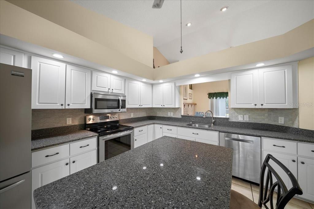 9660 Southwest 196th Avenue Road Dunnellon, FL 34432 - Photo 60 of 67 a kitchen with stainless steel appliances granite countertop a sink a stove and cabinets