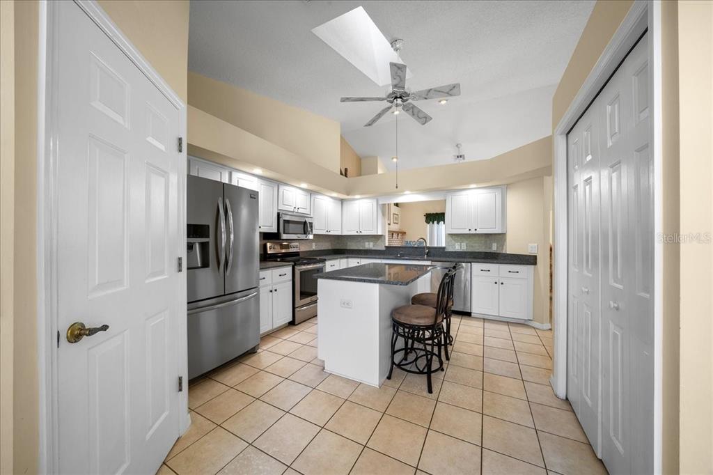 9660 Southwest 196th Avenue Road Dunnellon, FL 34432 - Photo 63 of 67 a kitchen with stainless steel appliances a refrigerator and a stove top oven