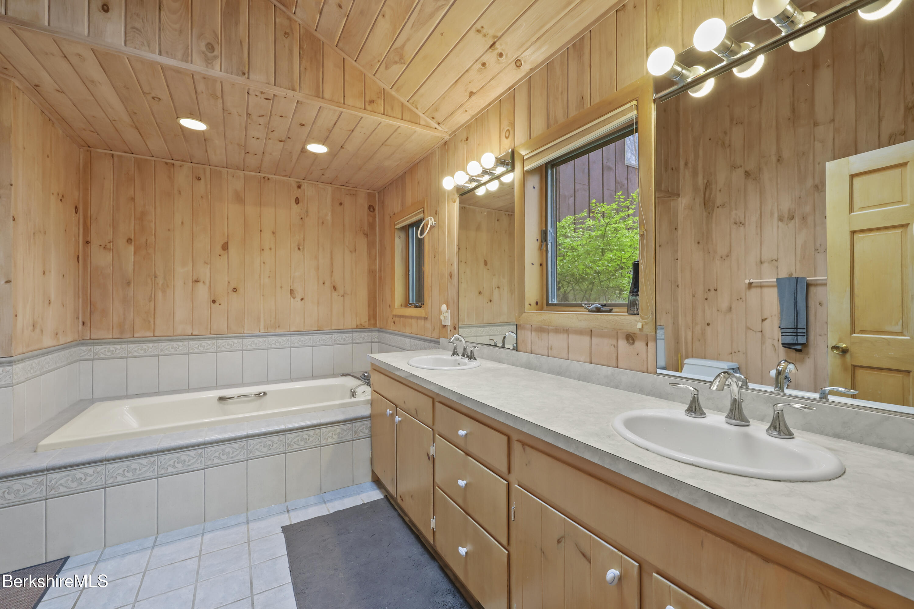 422 Bonny Rigg Hill Road Becket, MA 01223 - Photo 20 of 60 a bathroom with a granite countertop sink mirror and a bathtub