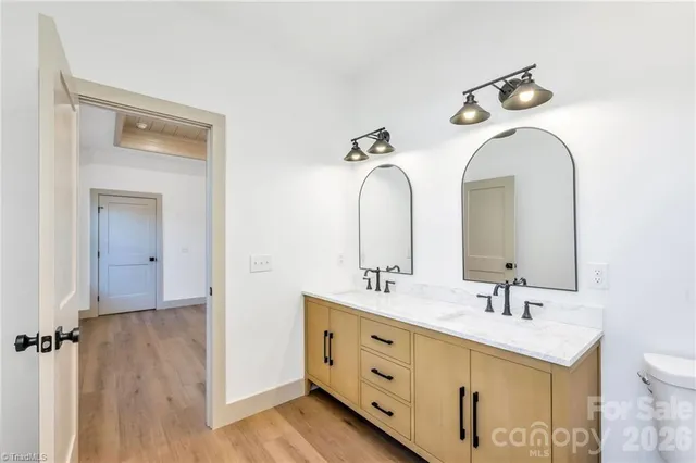a bathroom with a double vanity sink and mirror