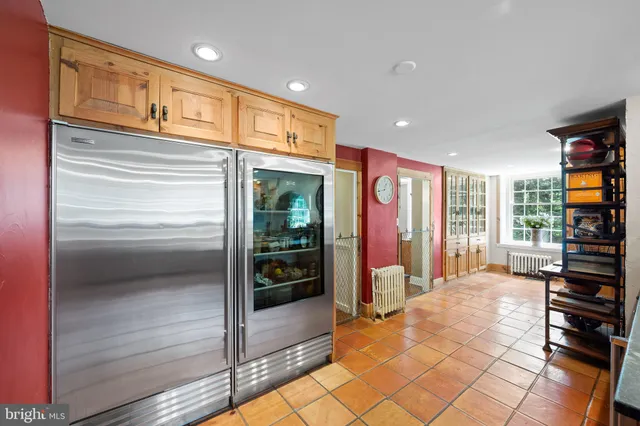a hallway with front door wooden floor and a window