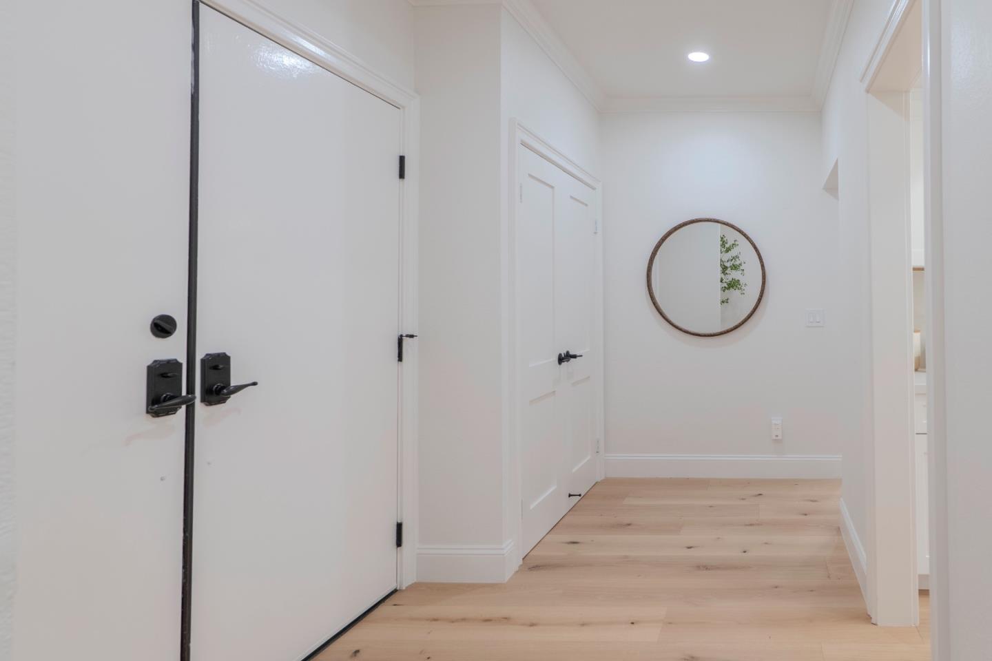 22330 Homestead Road, Unit 116 Cupertino, CA 95014 - Photo 17 of 30 a view of a room with wooden floor and mirror