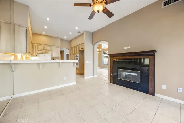 a open kitchen view with fireplace and cabinets